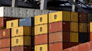 Bank of Japan holds rates, lowers growth forecasts
