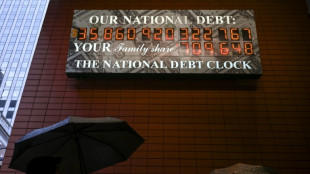 Stocks firm, dollar drops at end of rocky week